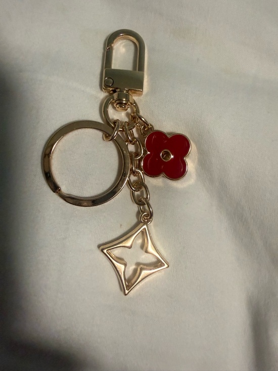 The Unbranded Brand Accessories - KeyChain with a hook for Bags with Red Flower Charm and gold tone accents!